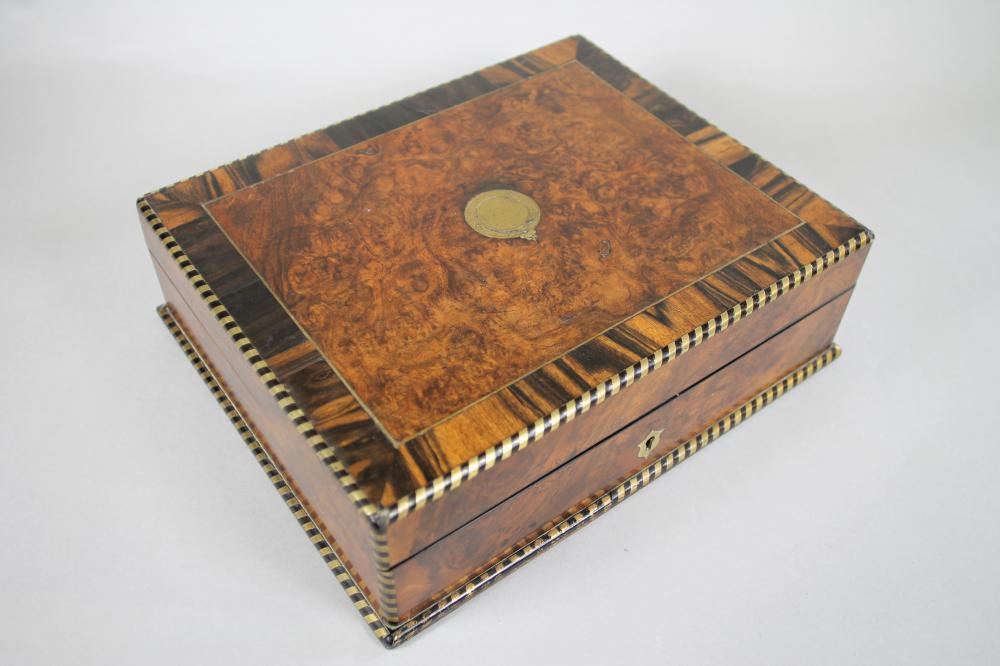 A VICTORIAN BURR WALNUT LAP DESK of plain oblong form crossbanded in coromandel and strung in brass Image