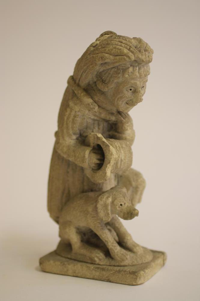 A LIMESTONE CARVING of a medieval monk Image