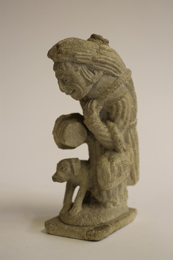 A LIMESTONE CARVING of a medieval monk Image