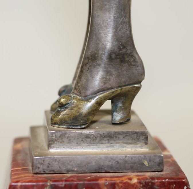 AN ART DECO COLD PAINTED SILVERED METAL FIGURE Image