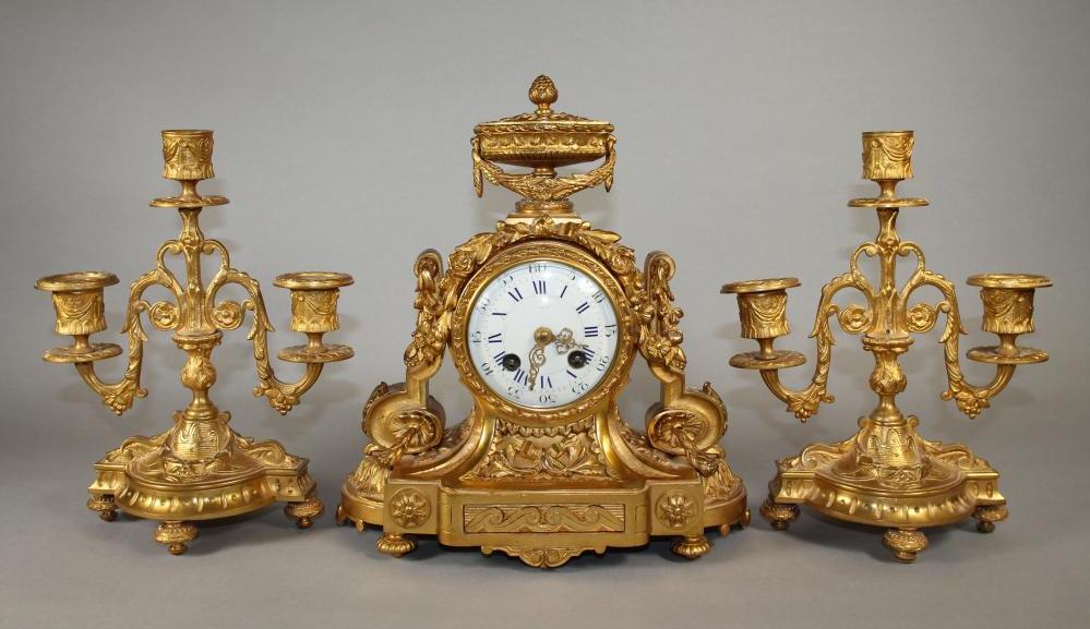 A FRENCH GILT METAL CLOCK GARNITURE Image