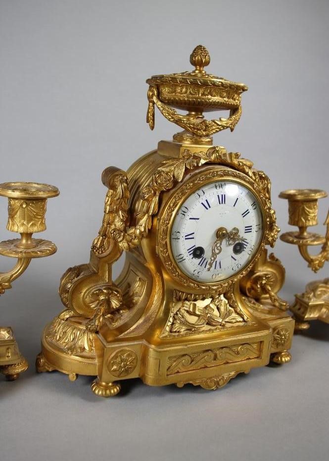 A FRENCH GILT METAL CLOCK GARNITURE Image