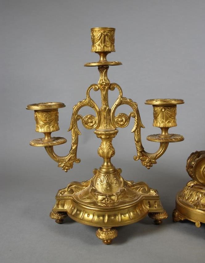 A FRENCH GILT METAL CLOCK GARNITURE Image