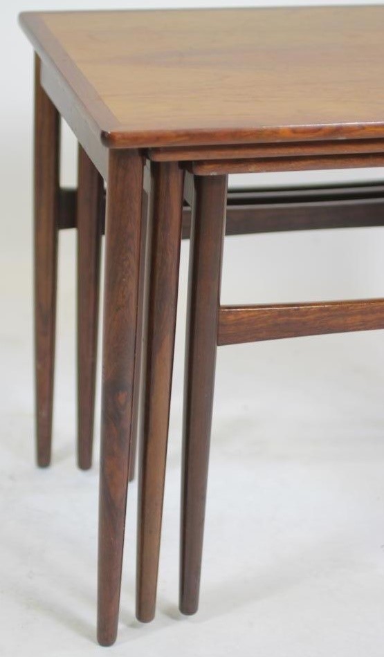 A NEST OF THREE TEAK TABLES Image