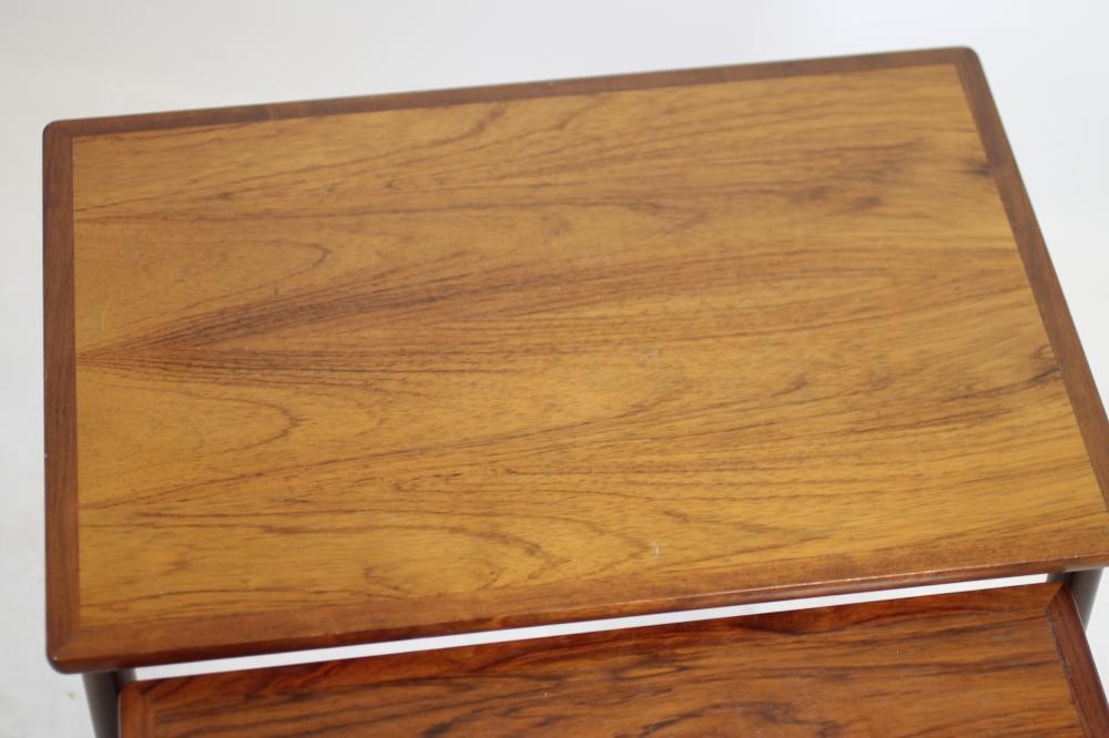 A NEST OF THREE TEAK TABLES Image