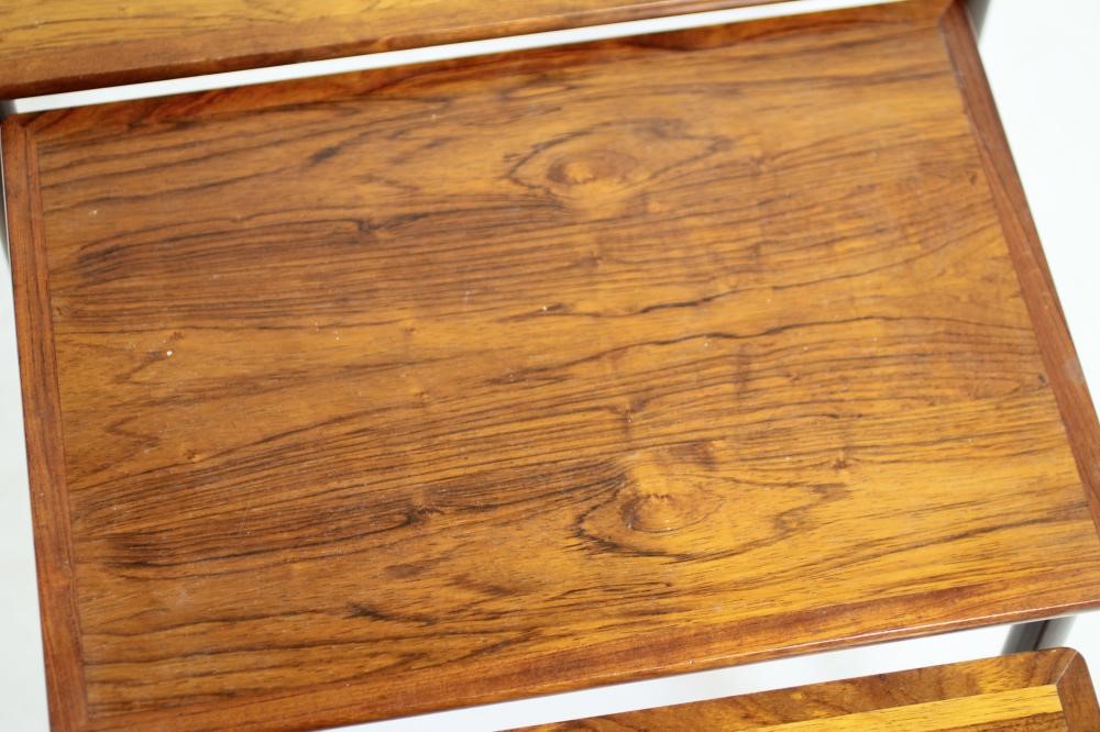 A NEST OF THREE TEAK TABLES Image