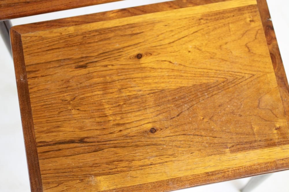 A NEST OF THREE TEAK TABLES Image