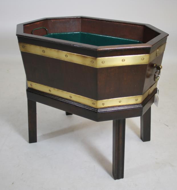 A GEORGIAN DESIGN MAHOGANY AND BRASS BOUND CELLARETTE of canted oblong form with brass loop handles Image