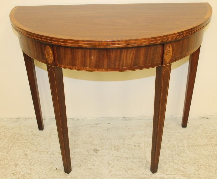 A GEORGIAN MAHOGANY FOLDING TEA TABLE of demi lune form with satinwood banding and stringing Image