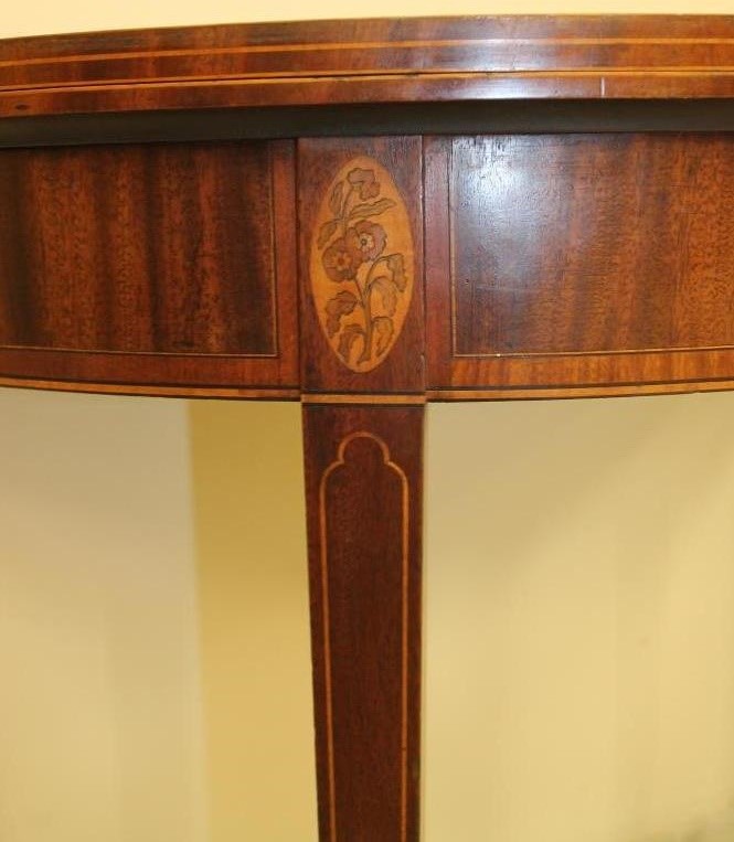 A GEORGIAN MAHOGANY FOLDING TEA TABLE of demi lune form with satinwood banding and stringing Image