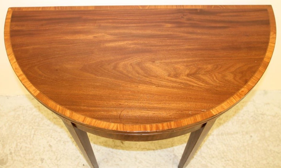A GEORGIAN MAHOGANY FOLDING TEA TABLE of demi lune form with satinwood banding and stringing Image