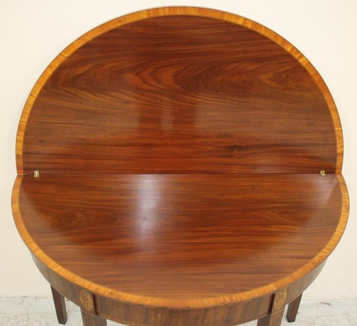 A GEORGIAN MAHOGANY FOLDING TEA TABLE of demi lune form with satinwood banding and stringing Image