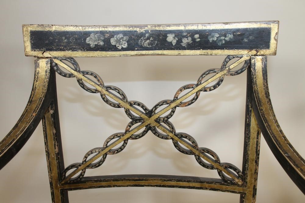 A PAIR OF REGENCY EBONISED AND PARCEL GILT "FANCY" ELBOW CHAIRS Image