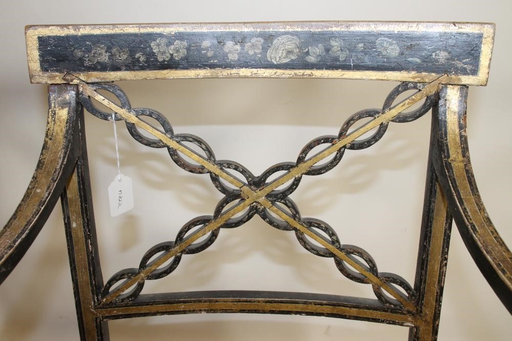 A PAIR OF REGENCY EBONISED AND PARCEL GILT "FANCY" ELBOW CHAIRS Image