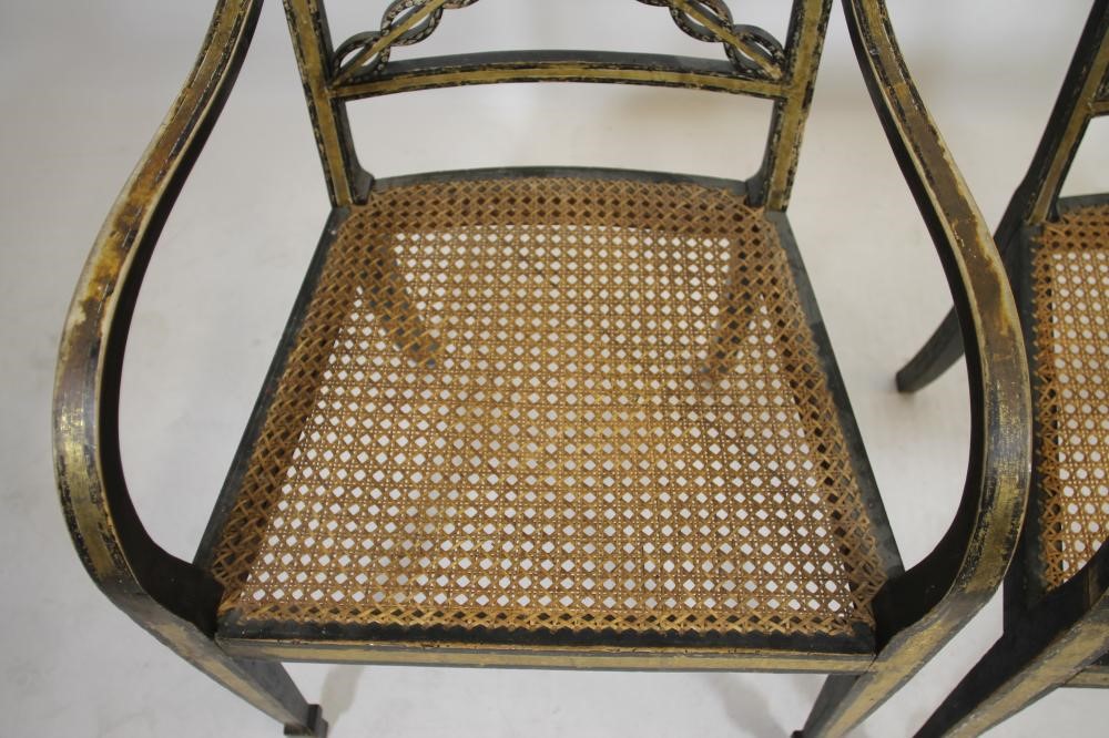 A PAIR OF REGENCY EBONISED AND PARCEL GILT "FANCY" ELBOW CHAIRS Image