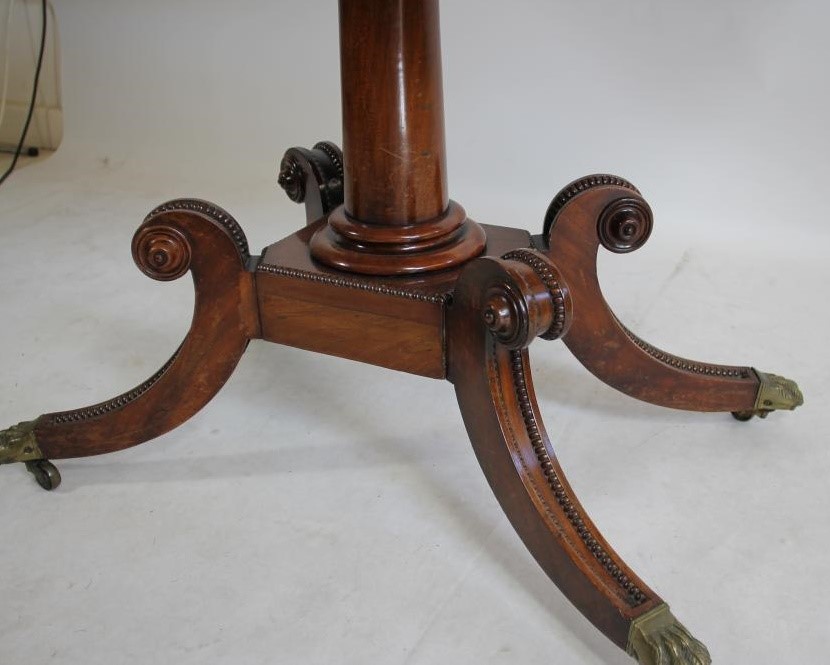 A REGENCY MAHOGANY FOLDING CARD TABLE of rounded oblong form with stringing and beaded edging Image