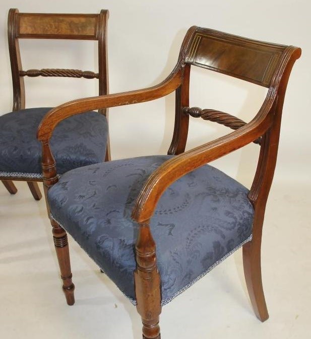 A COMPOSITE SET OF TWELVE REGENCY MAHOGANY DINING CHAIRS covered in deep blue damask and comprising Image
