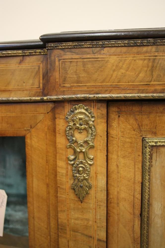 A VICTORIAN WALNUT AND EBONISED CREDENZA of breakfront D form with stringing and gilt metal mounts Image