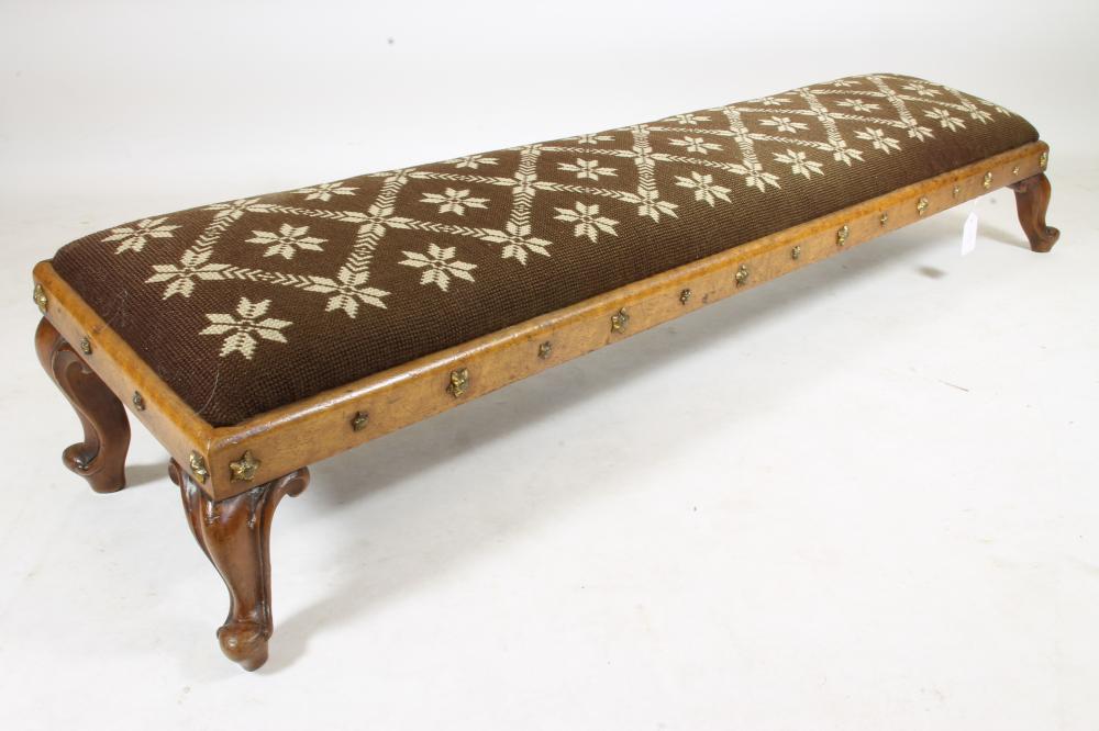 A VICTORIAN WALNUT FENDER STOOL of shallow oblong form studded with gilt metal stars Image