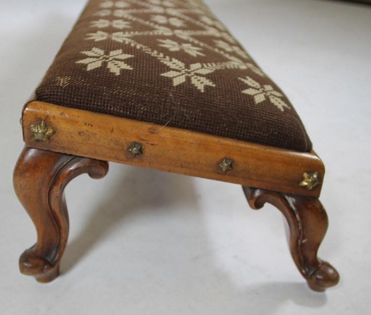 A VICTORIAN WALNUT FENDER STOOL of shallow oblong form studded with gilt metal stars Image