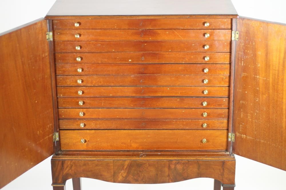 AN EDWARDIAN MAHOGANY SPECIMEN CABINET of oblong form with stringing Image