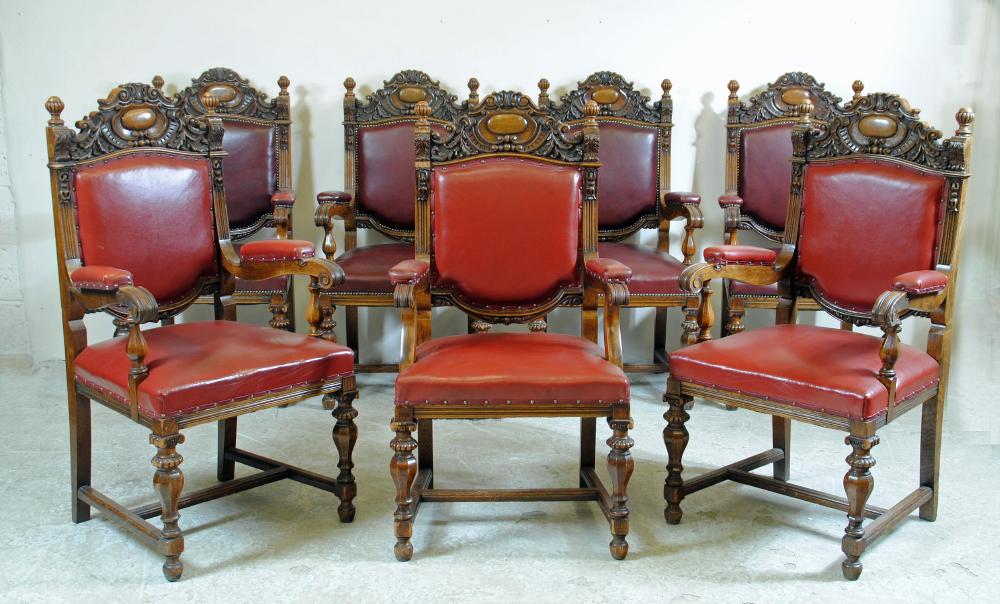 A SET OF FIVE VICTORIAN CARVED OAK ELBOW CHAIRS upholstered in red leather Image