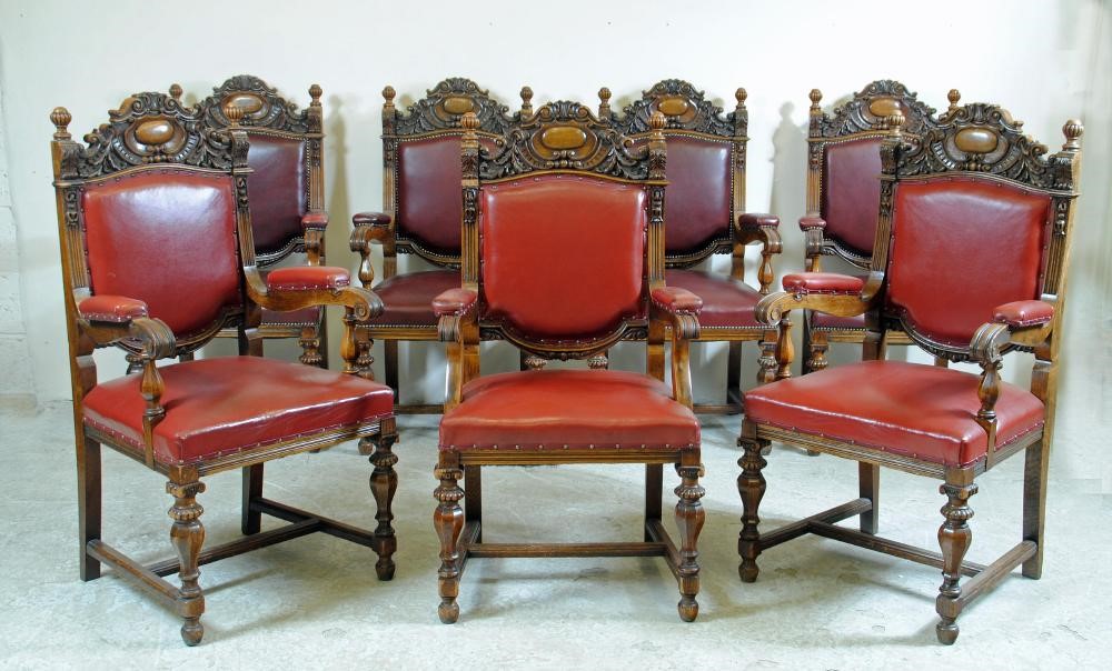 A SET OF FIVE VICTORIAN CARVED OAK ELBOW CHAIRS upholstered in red leather Image