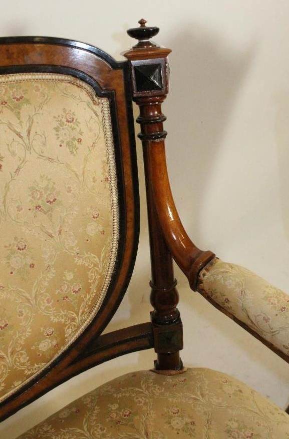 A VICTORIAN WALNUT AND EBONISED PART SALON SUITE upholstered in cream floral silk weave Image