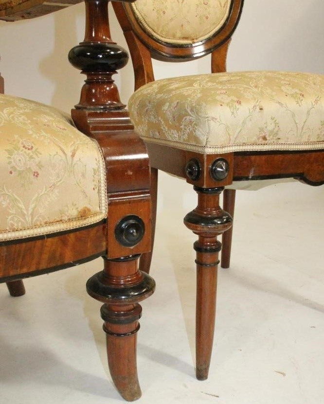 A VICTORIAN WALNUT AND EBONISED PART SALON SUITE upholstered in cream floral silk weave Image