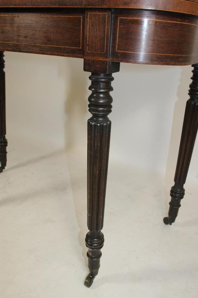 A REGENCY ROSEWOOD FOLDING CARD TABLE of rounded oblong form crossbanded with stringing Image