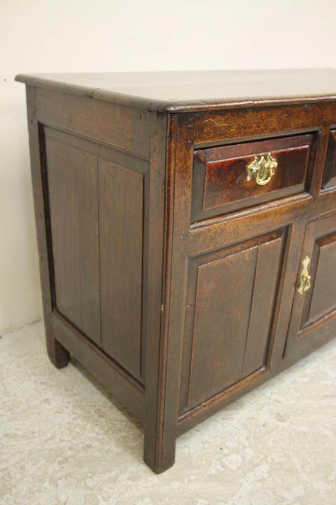 A GEORGIAN OAK ENCLOSED PANELLED DRESSER Image