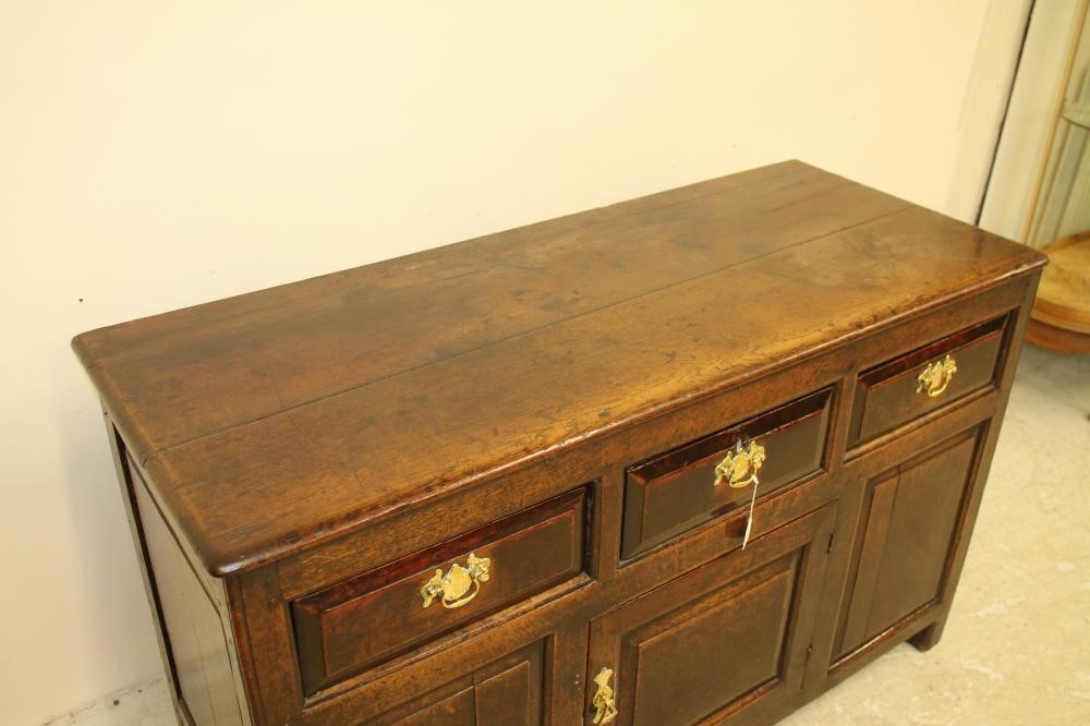 A GEORGIAN OAK ENCLOSED PANELLED DRESSER Image