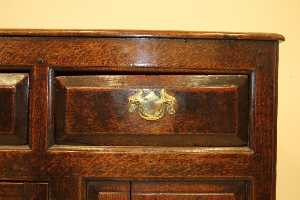 A GEORGIAN OAK ENCLOSED PANELLED DRESSER Image