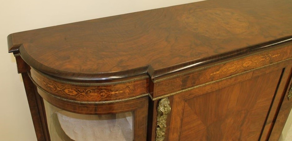 A VICTORIAN WALNUT AND EBONISED CREDENZA of breakfront D form with foliate marquetry and gilt metal Image