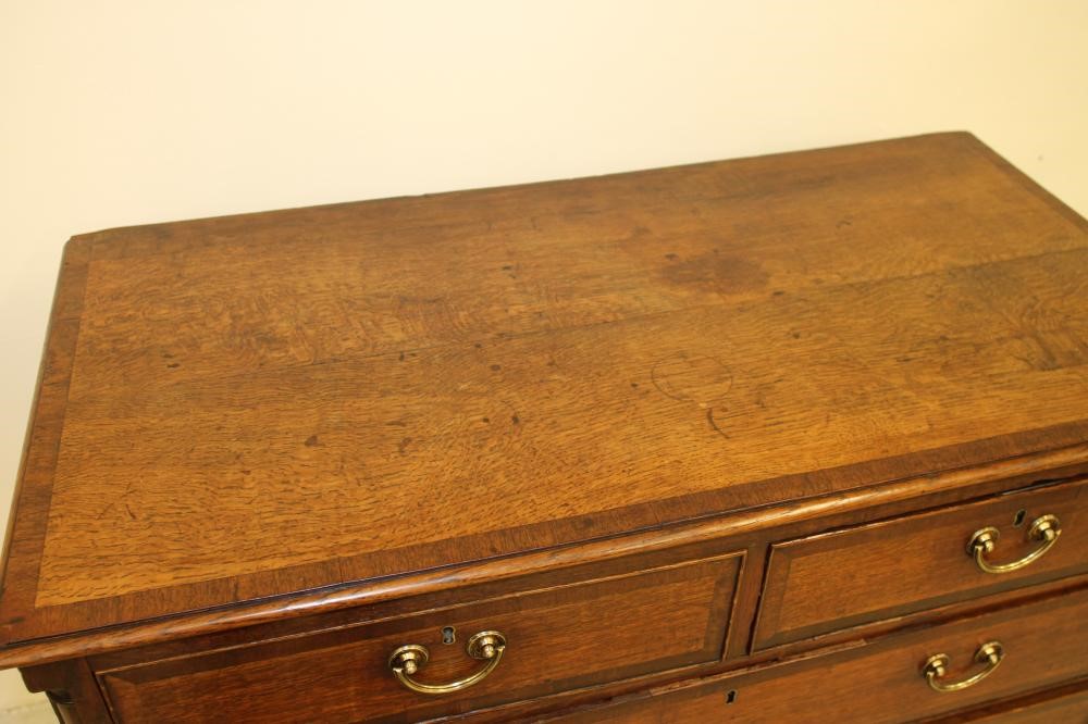 A GEORGIAN OAK AND MAHOGANY BANDED CHEST Image
