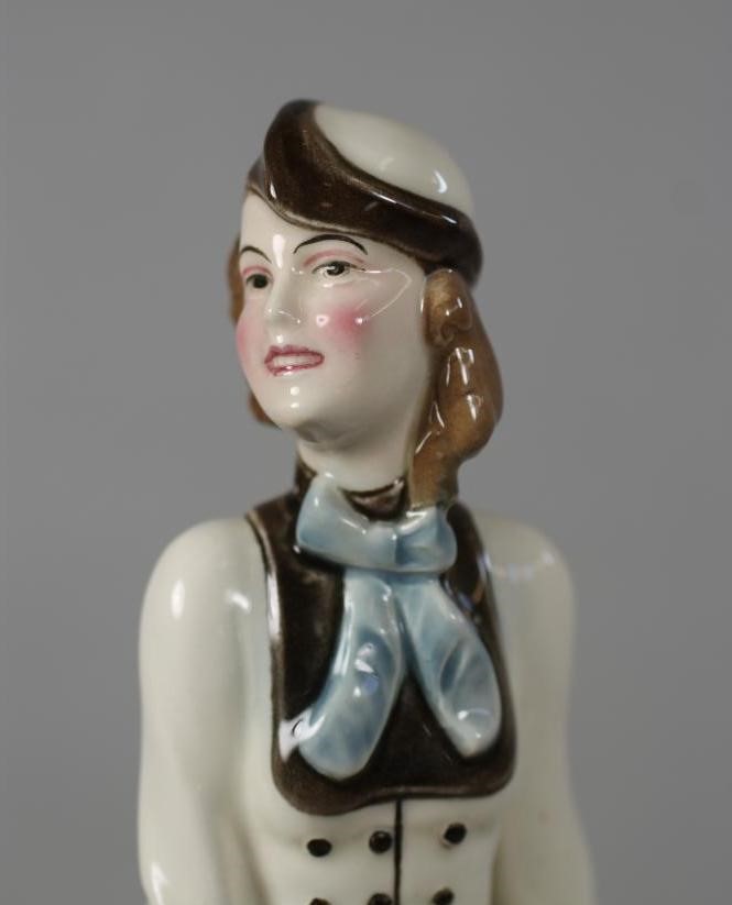 AN ART DECO KATZHUTTE EARTHENWARE FIGURE modelled as a stylish young lady wearing a hat and blue Image