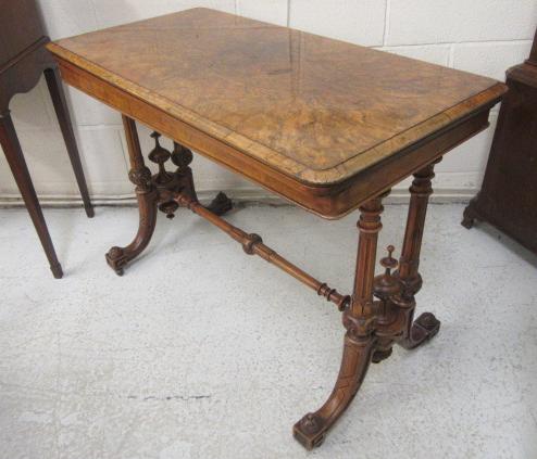 A VICTORIAN CARVED WALNUT FOLDING CARD TABLE Image