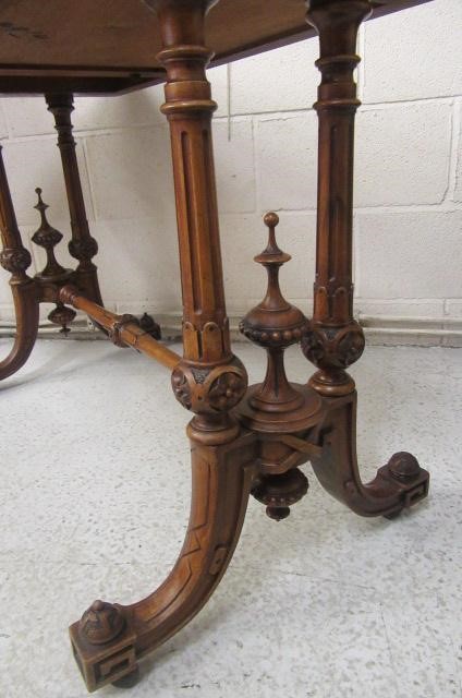 A VICTORIAN CARVED WALNUT FOLDING CARD TABLE Image