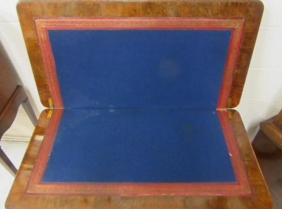 A VICTORIAN CARVED WALNUT FOLDING CARD TABLE Image