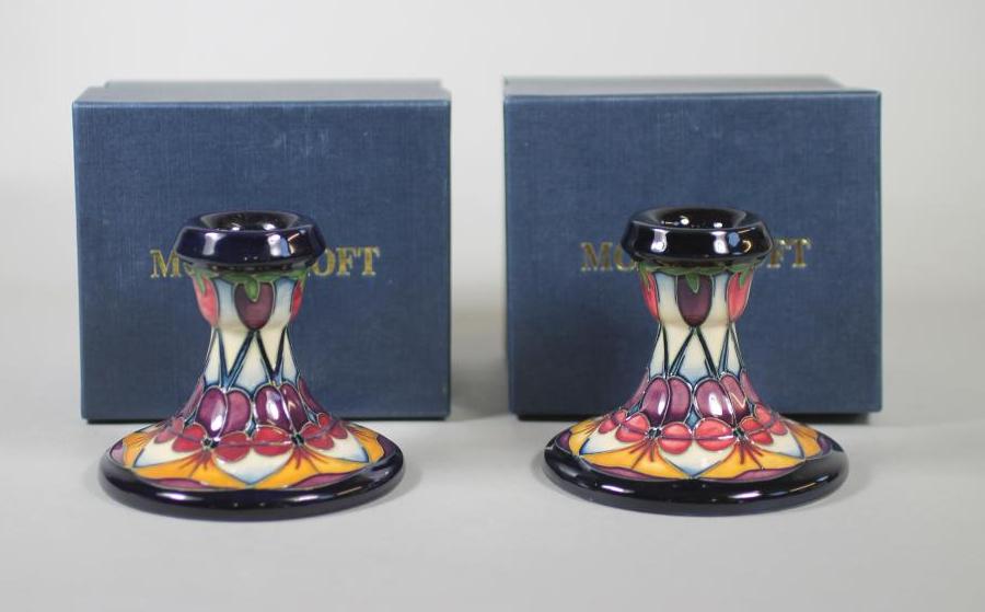 A PAIR OF MOORCROFT POTTERY DWARF CANDLESTICKS Image