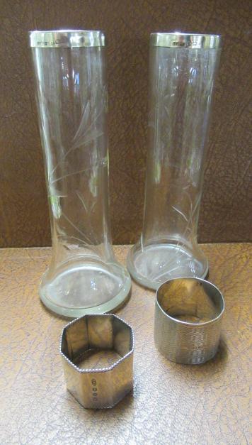 SILVER NAPKIN RINGS AND TWO SILVER TOPPED VASES Image