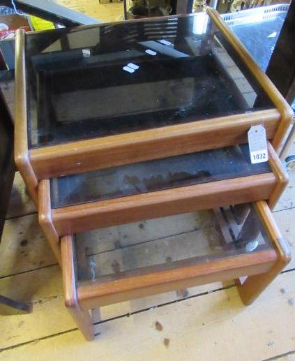 NEST OF THREE RETRO TEAK AND SMOKED GLASS TABLES Image