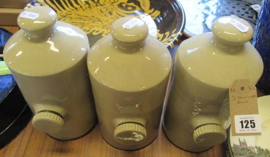 THREE STONEWARE HOT WATER BOTTLES Image