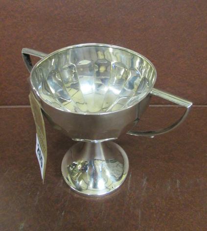 SILVER TROPHY ON WOODEN PLINTH Image