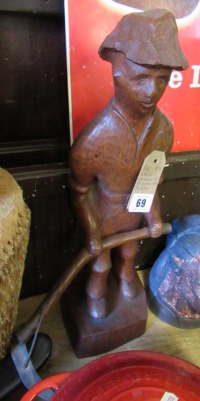 NATIVE CARVING OF A MAN WITH A SCYTHE Image