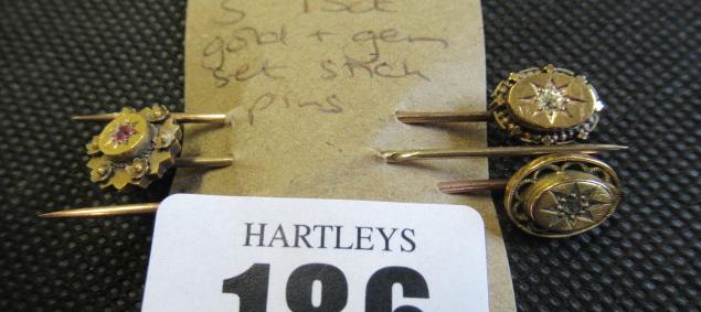 THREE 15CT GOLD AND GEM SET STICK PINS Image