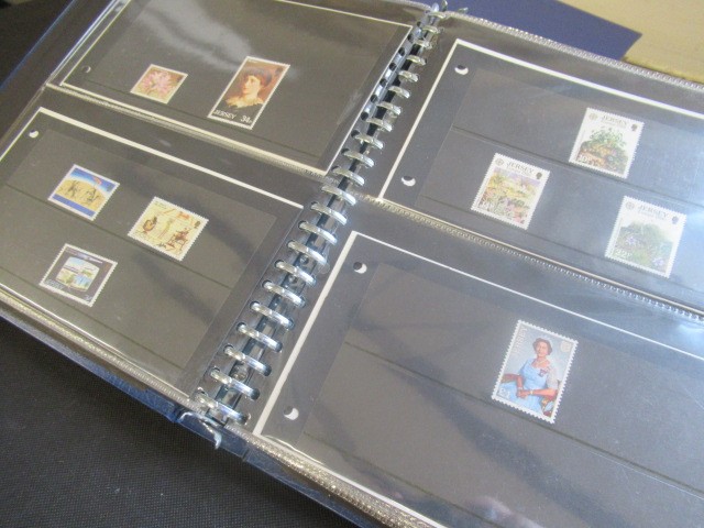 THREE ALBUMS OF MINT JERSEY STAMPS INCLUDING £5 EXAMPLE  Image