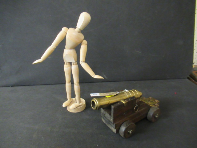BRASS CANNON AND AN ARTISTS LAY FIGURE Image
