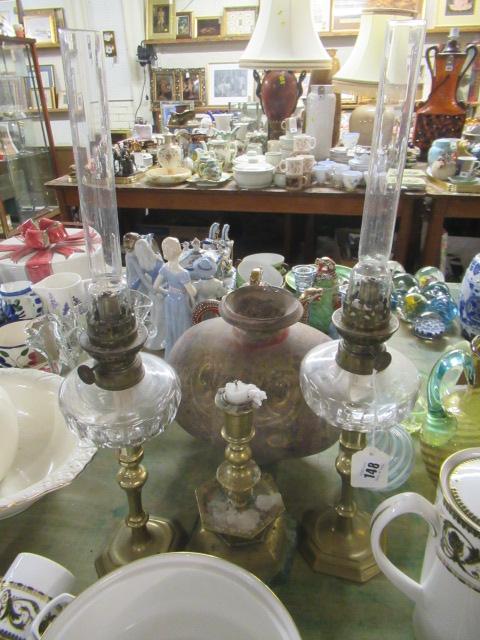 TWO OIL LAMPS AND A BRASS CANDLESTICK Image