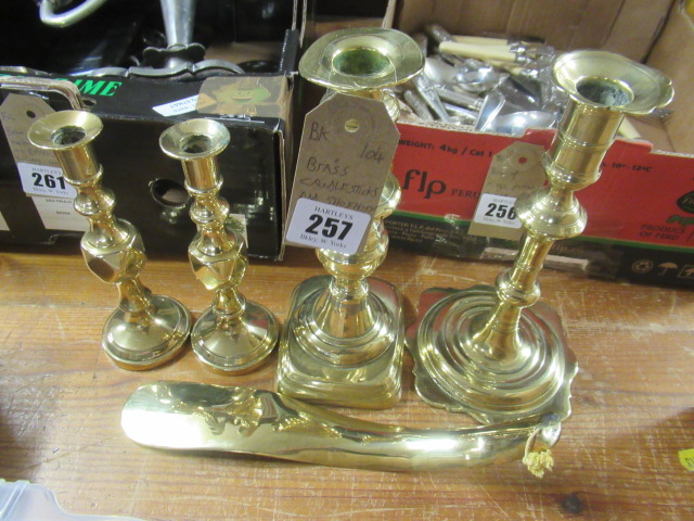 FOUR BRASS CANDLESTICKS AND A BRASS SHOE HORN Image